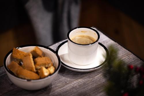 a cup of coffee and a bowl of food on a table at Chalets Alpglück in Oberstdorf