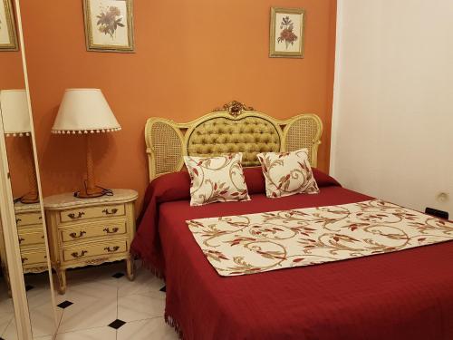 a bedroom with a bed and a lamp and a table at CASA RURAL EL ROCINANTE in Miguel Esteban