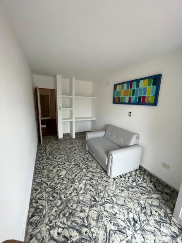 a living room with a couch and a carpet at Departamento zona centro , Catamarca in San Fernando del Valle de Catamarca