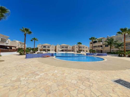 a swimming pool in the middle of a resort at Mermaid Holiday Apartments in Mandria