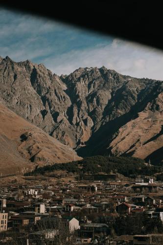 a view of a city with mountains in the background at Paramount Kazbegi in Stepantsminda