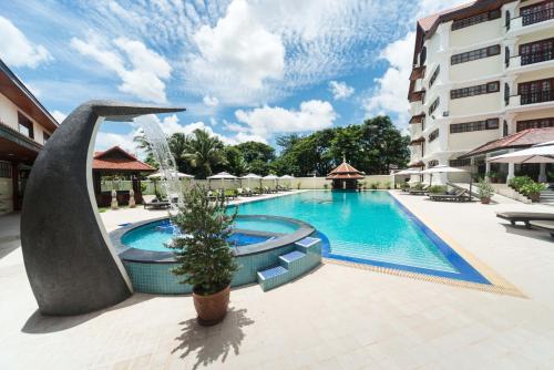 a swimming pool in front of a building at Regency Angkor Hotel in Siem Reap