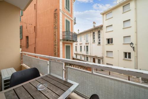 a balcony with a table and chairs on a balcony at Appartement Sauvalie - Welkeys in Le Cannet