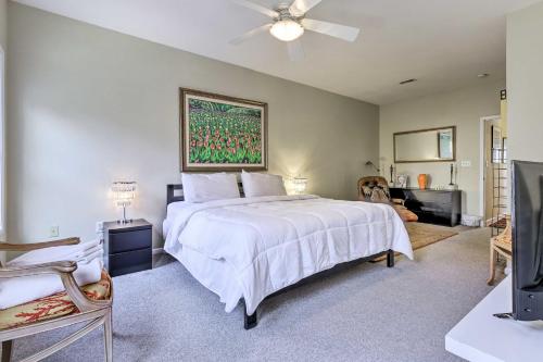 a bedroom with a white bed and a ceiling fan at 2 Mi to Ocean Rehoboth Beach Townhome with Grill! in Rehoboth Beach