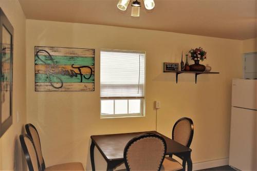 a kitchen with a table and chairs and a refrigerator at The Gateway in Grand Forks