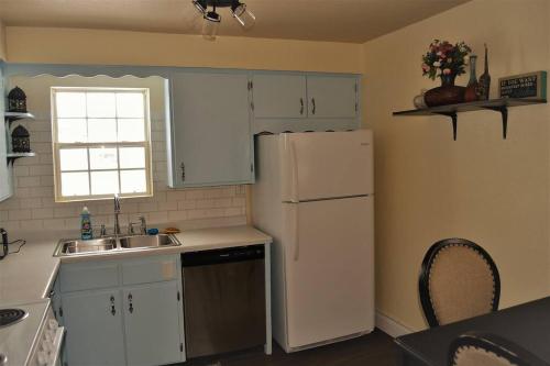 a kitchen with a white refrigerator and a sink at The Gateway in Grand Forks