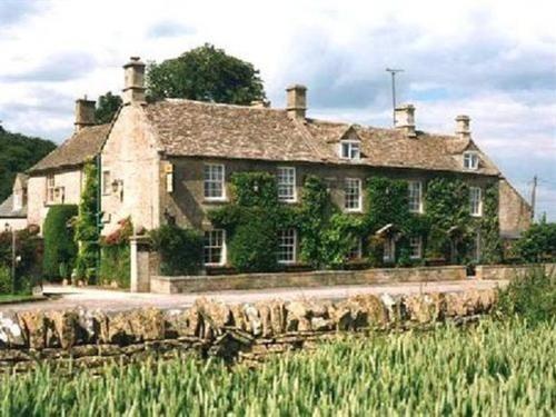 an old stone house with ivy on it at Inn for All Seasons in Burford