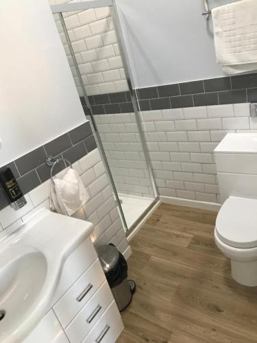 a bathroom with a white toilet and a sink at The Sunfold in Weston-super-Mare