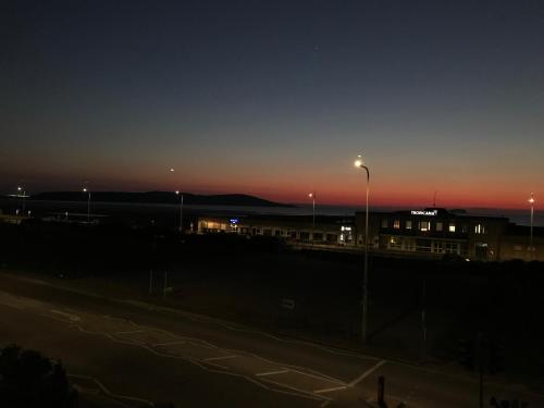 a night view of a parking lot with a street light at The Sunfold in Weston-super-Mare