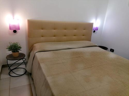 a bedroom with a large bed with two lights at ALLEGRA - Casa Vacanze Torre dell'Orso in Torre dell'Orso