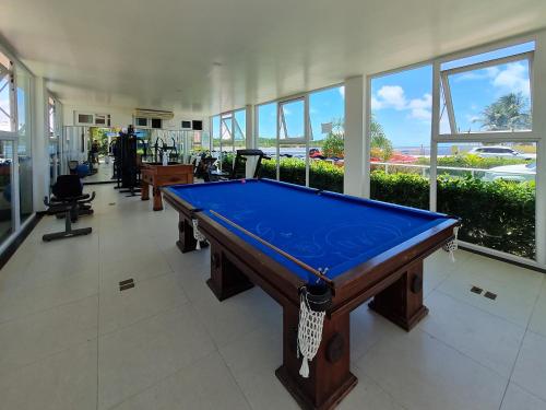 a pool table in a large room with windows at Pousada Jirituba in Barra de Santo Antônio