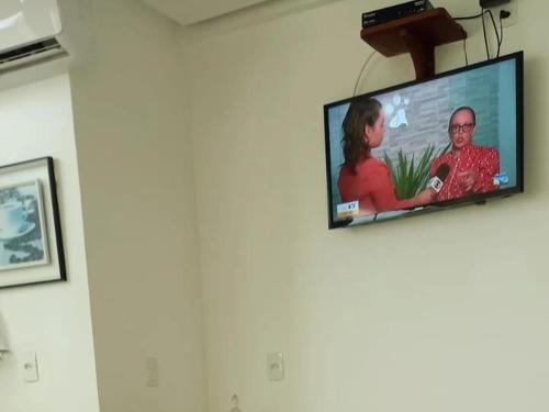 a flat screen tv hanging on a wall at Pousada Vilas Boas in Barreirinhas