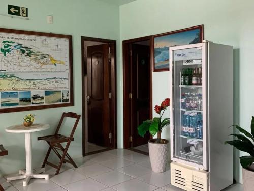 a room with a refrigerator with drinks in it at Pousada Vilas Boas in Barreirinhas