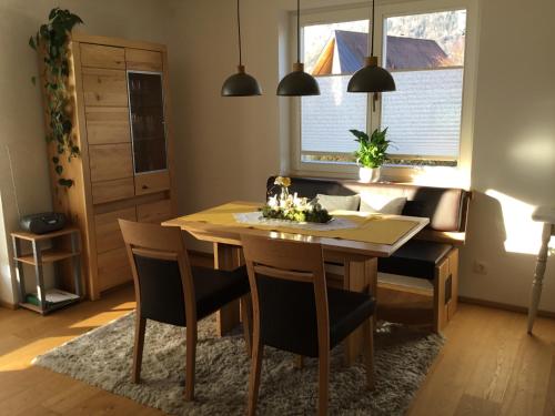 a dining room with a wooden table and chairs at Ferienwohnung Neureiter in Golling an der Salzach