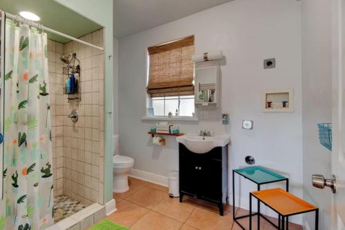 a bathroom with a shower and a sink and a toilet at Spanish Bungalow Guest House in Daytona Beach