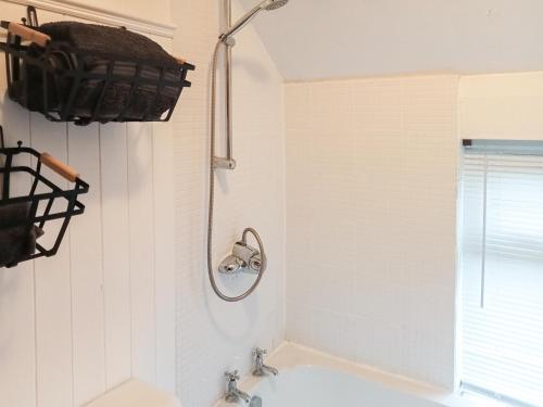 a bathroom with a sink and a shower at Post Cottage in Hulland