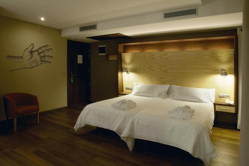 Postel nebo postele na pokoji v ubytování SOMMOS Hotel Aneto