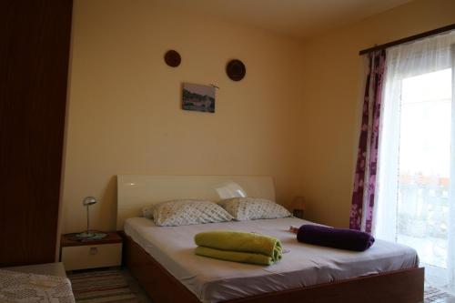 a bedroom with a bed with two pillows on it at Apartman Zaton in Zaton