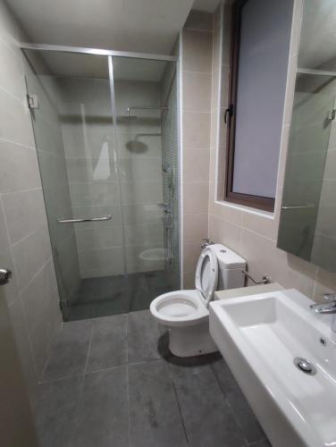 a bathroom with a shower and a toilet and a sink at Bali Residence Melaka by Jzstay 2BR in Melaka