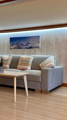 a living room with a couch and a coffee table at CLOUD No3, Interlaken in Matten