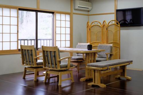 a conference room with a wooden table and chairs at Miyoshino Sakuraan in Yoshino