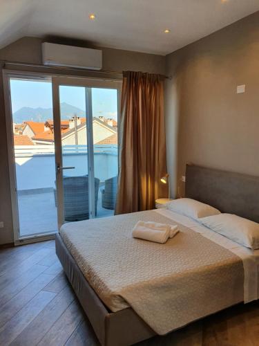a bedroom with a bed with a view of a balcony at Le Ochette Di Stresa in Stresa