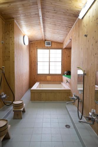 a large bathroom with a tub and a window at Miyoshino Sakuraan in Yoshino