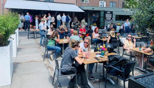 a group of people sitting at tables at a restaurant at Boutique Hotel Brasa Beemster in Middenbeemster