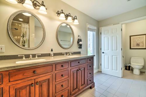 a bathroom with a sink and two mirrors at Nashville Area Family Getaway with Private Pool! in Pegram