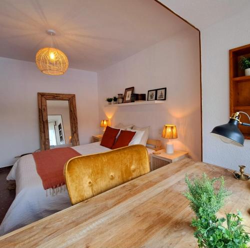 a bedroom with a large bed and a mirror at El Chalet de los molinos in Los Molinos