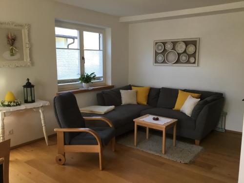 a living room with a couch and a table at Ferienwohnung Neureiter in Golling an der Salzach