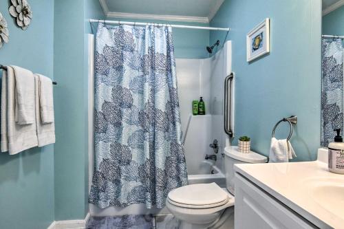 a blue bathroom with a toilet and a shower curtain at Milton Townhouse about 9 Mi to Delaware Bay! in Milton
