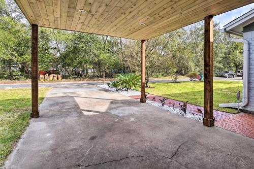 an empty porch of a house with a wooden roof at Emerald Coast Vacation Rental 1 Mi to Beach in Shalimar