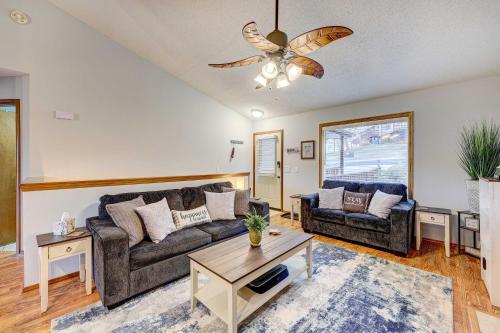 a living room with two couches and a ceiling fan at Holiday Island Vacation Rental with 2 Balconies in Holiday Island