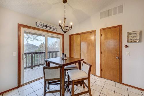 a dining room with a table and chairs and a balcony at Holiday Island Vacation Rental with 2 Balconies in Holiday Island