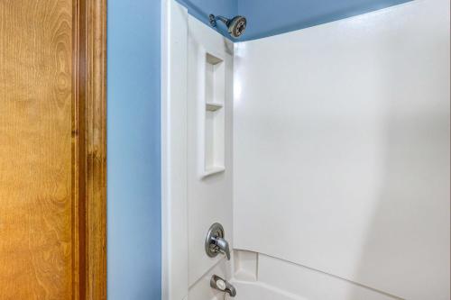 a bathroom with a white door and a shower at Holiday Island Vacation Rental with 2 Balconies in Holiday Island