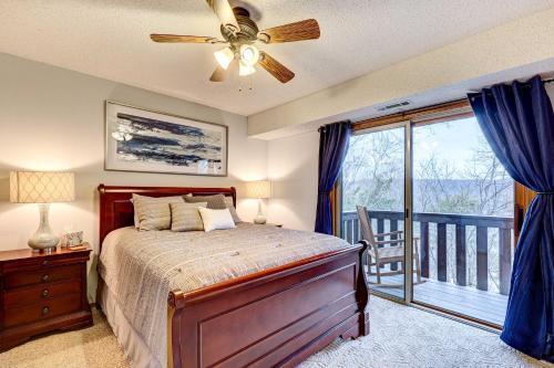 a bedroom with a bed with a ceiling fan and a balcony at Holiday Island Vacation Rental with 2 Balconies in Holiday Island
