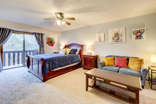 a bedroom with a bed and a couch at Holiday Island Vacation Rental with 2 Balconies in Holiday Island