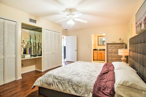 a bedroom with a bed and a ceiling fan at Riviera Beach Vacation Home with Pool Walk to Beach in Riviera Beach