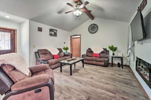 a living room with two couches and a ceiling fan at Missouri Retreat about 7 Mi to Silver Dollar City in Branson West