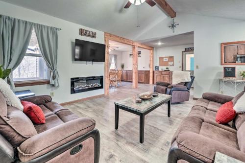 a living room with two couches and a table at Missouri Retreat about 7 Mi to Silver Dollar City in Branson West