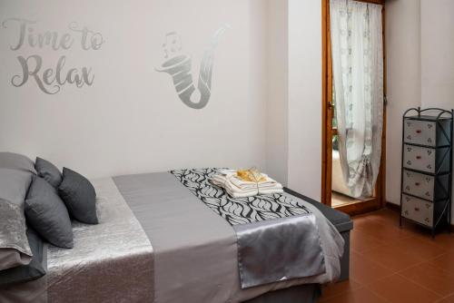 a bedroom with a bed with a gray blanket and a mirror at Le Stanze di Morgana intero appartam. Monterotondo in Monterotondo
