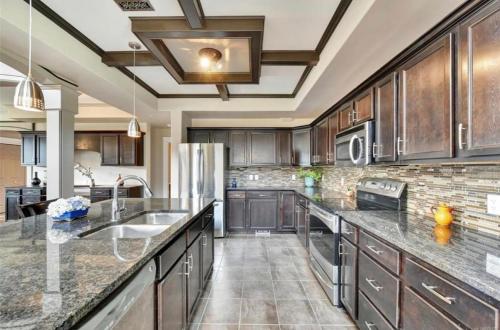 a kitchen with wooden cabinets and a large counter top at Large Executive Home in Mill Springs , 4 bd and 3 ba in Mill Bay