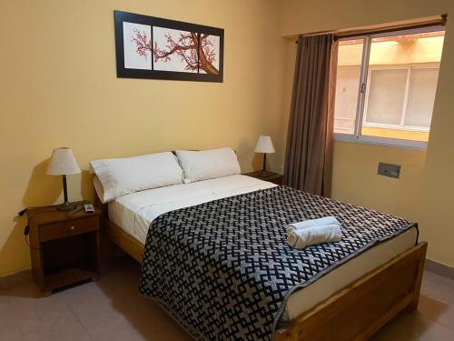 a bedroom with a bed and a window at Hotel Itavera in Puerto Iguazú