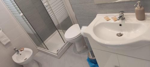 a bathroom with a sink and a toilet and a shower at InBlu in Bari