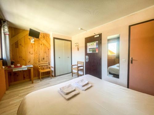 a bedroom with a bed with two towels on it at Atmosphere Hotel in Les Deux Alpes
