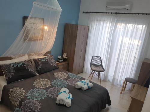 a bedroom with two stuffed animals on a bed at House Near The Beach (Militsa & Aggeliki) in Perivolia