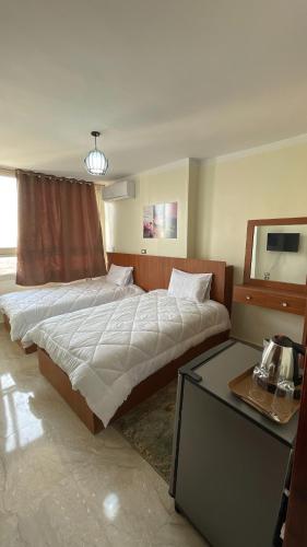 a bedroom with a large bed and a table at Aladdin pyramids City 2 in Cairo