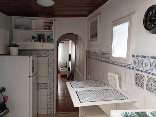 a kitchen with a table and a window at Alfama with a view in Lisbon