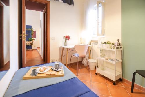 a small room with a bed and a table at Pulcinella Home in Naples